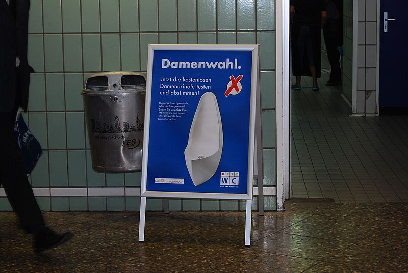 File:Advertisement for waterless urinals in front of ladies entrance (5880397908).jpg