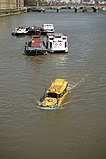 Amphibious tour bus – a converted DUKW – on Thames river in London near Lambeth Bridge.