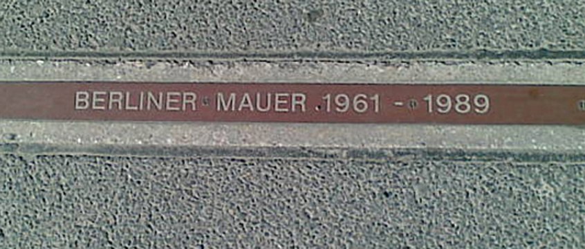 A "BERLINER MAUER 1961–1989" plaque near Checkpoint Charlie signifying where the Wall stood