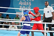 Deutsch: Boxen bei den Olympischen Jugendspielen 2018 Tag 12, 18. Oktober 2018 - Finale Fliegengewicht Mädchen – Martina La Piana (Italien, blau) schlägt Adijat Gbadamosi (Nigeria, rot) 5-0; Ringrichter ist James Beckles (Trinidad und Tobago). English: Boxing at the 2018 Summer Youth Olympics on 18 October 2018 – Girl's flyweight Gold Medal Bout - Martina La Piana (Italy, blue) beats Adijat Gbadamosi (Nigeria, red) 5-0; Referee is James Beckles (Trinidad and Tobago). Español: Boxeo en los Juegos Olímpicos Juveniles de Verano de 2018 en 18 de octubre de 2018 - Combate a medalla de oro de peso mosca para mujeres: Martina La Piana (Italia, azul) le gana a Adijat Gbadamosi (Nigeria, roja) 5-0; El árbitro es James Beckles (Trinidad y Tobago).