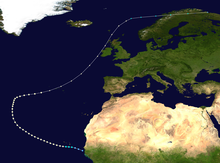 Path of a hurricane, with colored dots representing the storm's intensity at different positions in six-hour intervals. The storm begins in the lower-center of the image near a landmass, moves left, up, and then generally moves towards the upper-right corner of the image. The colored dots reflect a gradual increase and then decrease in intensity.