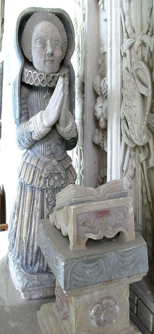 Small kneeling effigy of Elizabeth Rolle, on monument to her second husband Sir John Acland (died 1620) of Columb John, in Broadclyst Church