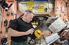 Wilmore is shown inside Node 1 of the ISS reading an instruction manual on using an IMAX camera. Expedition 41 Wilmore reads about IMAX camera.jpg