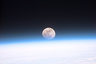 صُورة التُقطت من على متن مكُّوك الفضاء ديسكڤري يوم 21 كانون الأوَّل (ديسمبر) 1999م، لِظاهرةٍ نادرًا ما تُرى، هي حجب غلاف الأرض الجوي جزئيًا لِلبدر