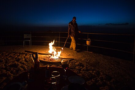 Habtamu tending the fire close to dining tables at Ben Abeba, January 2018