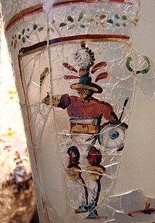 Enamelled glass depicting a gladiator, found at Begram, Afghanistan, which was once part of the Greco-Bactrian Kingdom, but was ruled by the Kushan Empire during the contemporaneous Roman Principate period, to which the glass belongs, 52-125 AD (although there is some scholarly debate about the precise dating). Gladiateur Begram Guimet 18117.jpg