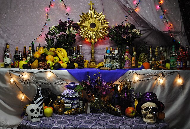 Vodou altar celebrating Papa Guédé in Boston, Massachusetts, featuring offerings to Rada spirits, the Petwo family, and the Gede. In the center is a g