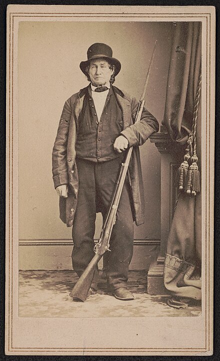 John L. Burns, veteran of the War of 1812, civilian who fought at the Battle of Gettysburg with Union troops, standing with bayoneted musket. Mathew Brady's National Photographic Portrait Galleries, photographer. From the Liljenquist Family Collection of Civil War Photographs, Prints and Photographs Division, Library of Congress