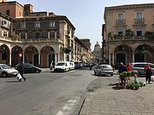 East flank of Piazza Mazzini, he palaces of Scammacca and Asmundo frame a view down via Garibaldi to the Catania Cathedral. Lato di Piazza Mazzini.jpg