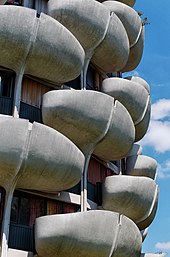 The curved balconies in front of each apartment's windows