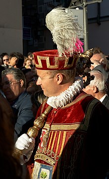 Spanish macero bearing a tabard with the coat of arms of the city of Madrid. Madrid - Fiestas de la Paloma - 20070815-12.jpg