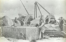 men working on a large block of stone