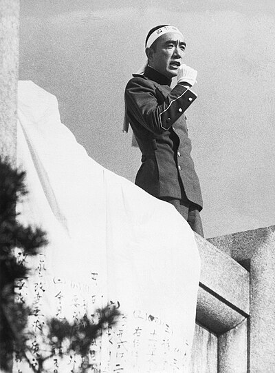 Mishima delivering his speech on the balcony