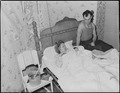 Mr. and Mrs. Andrew Broughton with their twelve hour old baby. They and their other son live in a four room house for... - NARA - 541152.tif