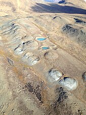 Aerial view of mud volcanoes on the Nahlin Plateau, British Columbia. Scale - each volcano approximately 20 m in diameter. Mud Volcanos.jpg