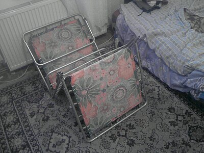An aluminum folding bed, of the sort widely used in many Eastern Bloc countries.[citation needed] The cloth is tensioned by metal springs all round