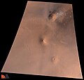 Hecates Tholus ligger øverst på bildet. Til høyre for toppen henger det hvite skyer. Elysium Mons er den midterste vulkanen på bildet og nede til hyre ligger Albor Tholus.