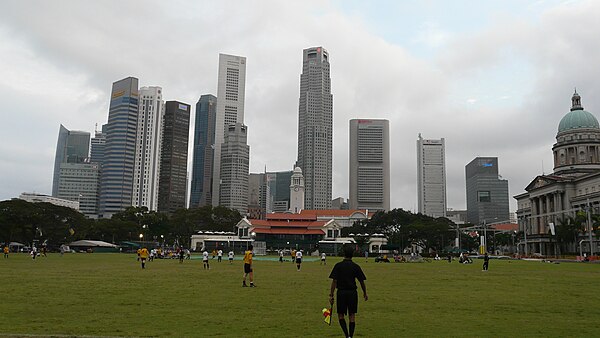 A football match at the Padang set against the Singapore skyline