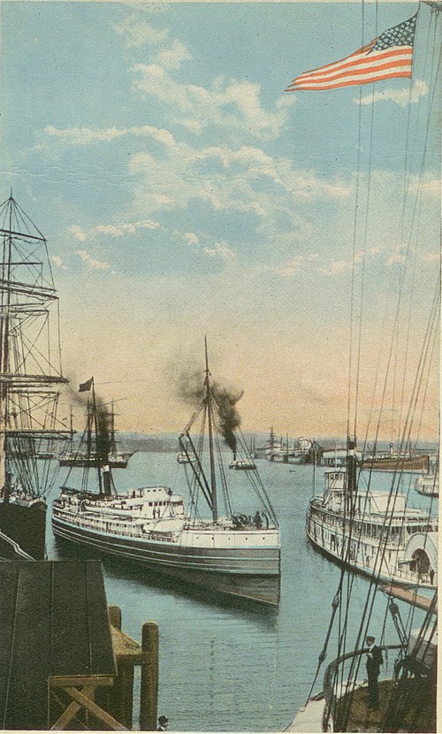 Portland harbor, probably in the early 1900s, showing tall ships, steamship, and, on right leaving the dock, the sternwheeler Bailey Gatzert