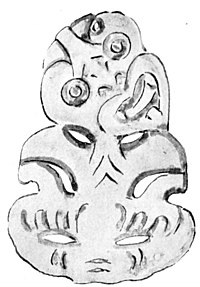 A carved tiki showing the cut-out neck. There is a small hole at the top of the head for a cord to loop through.