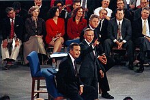 Photograph of President Bush, Ross Perot and Governor Clinton standing on a stage in front of a seated audience