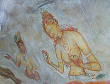Painting on a rock face depicting two women, one dark skinned and the other fair skinned. Both are wearing jewellery and flowers, and both figures appear to be hidden in clouds below the waist.