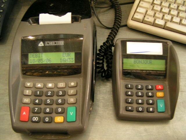 An older generation Ingenico credit card terminal and separate keypad from 2006