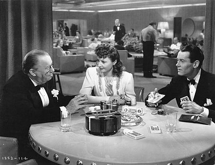 In The Lady Eve, Jean (center, played by Barbara Stanwyck) passes herself off as an upper-class woman.