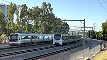 A Transperth A-series train (left) and a Transperth C-series train (right) on the Armadale line in Burswood Transperth C-series train between Burswood and Stadium stations, February 2023 05.jpg