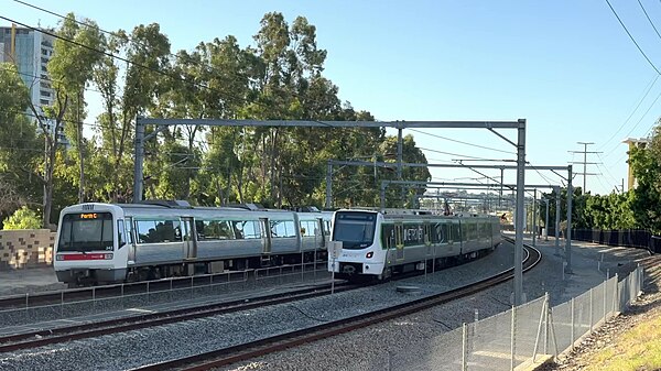 A Transperth A-series train (left) and a Transperth C-series train (right) on the Armadale line in Burswood