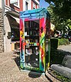 Public bookcase in Heimbach, a brightly painted former telephone booth