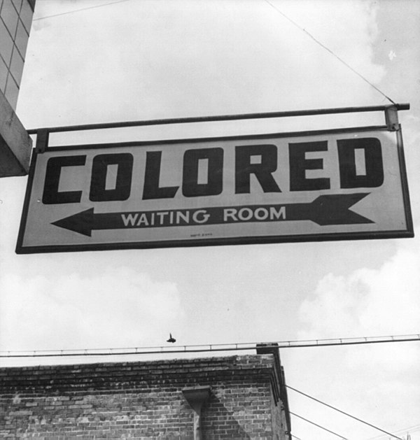 Sign for "colored" waiting room at a Greyhound bus terminal in Rome, Georgia, 1943. Throughout the South there were Jim Crow laws creating de jure leg