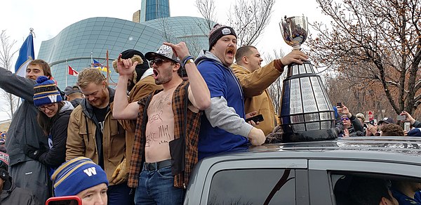 Members of the Blue Bombers with the Grey Cup during their championship parade in 2019.