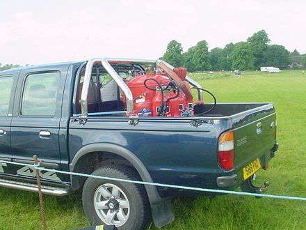 Heavy-duty CO2-powered fire extinguisher on standby at a temporary helicopter landing site