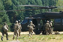 US Army troops getting on a UH-60 military helicopter preparing for air assault training at Nowa Deba, Poland, 2015 Air assault training 150807-A-JI163-018.jpg