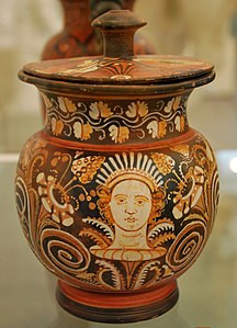 Apulian red-figure Oinochoe with Lid by the Ganymed Painter (Oinochoe) and Armidale Painter (Lid): head in a calyx between tendrils. About 340–310 BC. Antikensammlung Kiel.