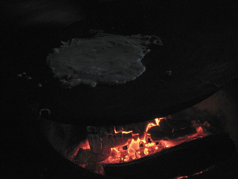 File:Braising crepes on an open fire.JPG