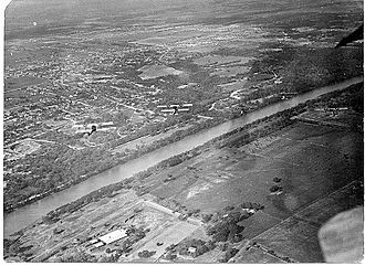 U.S. Army Air Corps Flyers from Rich Field over the Brazos River in Waco, 1918. It shows a formation of aircraft over the Brazos River and is one of the first aerial photos of Waco. Curtiss JN-4s from Rich Field over Waco Texas.jpg