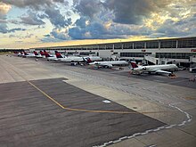 A view south along the McNamara Terminal at DTW (8/4/2020). Tails include aircraft types CRJ-900, A321, 737-900ER, A319, and A220. DTW McNamara Terminal South Ramp.jpg