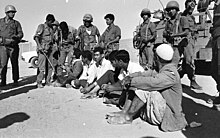 Israeli soldiers check Palestinian men in Gaza in 1969 Dan Hadani collection (990044373540205171).jpg