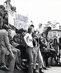 A Gay Liberation march in London, UK, c. 1972. A Gay Liberation Front banner is visible. Location is believed to be Trafalgar Square. Demonstration, with Gay Liberation Front Banner, c1972 (7374381322).jpg