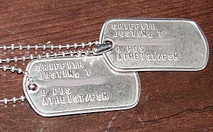 Two metal US Army dog tags with Atheist/FSM stamped on them