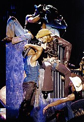 Madonna and her dancers perform second single "Don't Tell Me" dressed as cowboys on one of the concerts of 2001's Drowned World Tour. DontTellMeDionisioWeiland.jpg