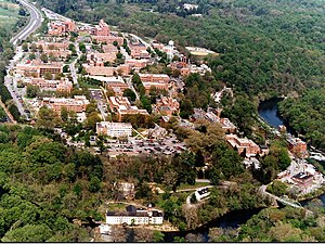 Aerial photo of the Dupont Experimental Station in the summer of 1997. The Brandywine Creek is in the immediate foreground and right. The stone building in the center of the picture is the original clubhouse of the Dupont Country Club which has now been displaced to the upper left of the photo. The Nemours Mansion and Gardens is seen in the upper center. Hagley Museum is off the picture to the immediate left. DuPont Experimental Station.JPG