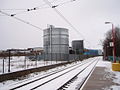 The view south west from Platform 1 across the tracks to storage tanks at the north east corner of the Nestlé Rowntree factory on Rowan Drive 2 January 2010