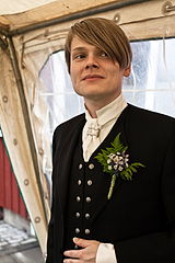 An Icelandic man wears the hátíðarbúningur formal dress on his wedding day along with a boutonnière.