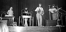 John Kirkpatrick (second from right) performing with Sue Harris (=Sue Kirkpatrick) (left), Geoff Harris (right) and Pennie Harris (second from left) at the 1977 Norwich Folk Festival Kirkpatrick-Harris-Kirkpatrick-Harris-Norwich 1977.jpg