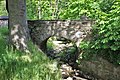 Round arch bridge over the monastery water, with weir