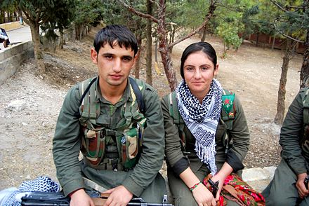Kurdish YPG and YPJ fighters in Syria with keffiyehs