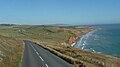 English: The A3055 Military Road, Isle of Wight, seen from a Southern Vectis bus on route 7, as it headed down from the the re-aligned section, while heading for Newport. The bus had just gone over the highest section of the road. The bus was 1052 (YU52 XVM). From the timetable change on 5 September 2010, this section of route 7 was withdrawn, and replaced by a more limited service on new route 12.